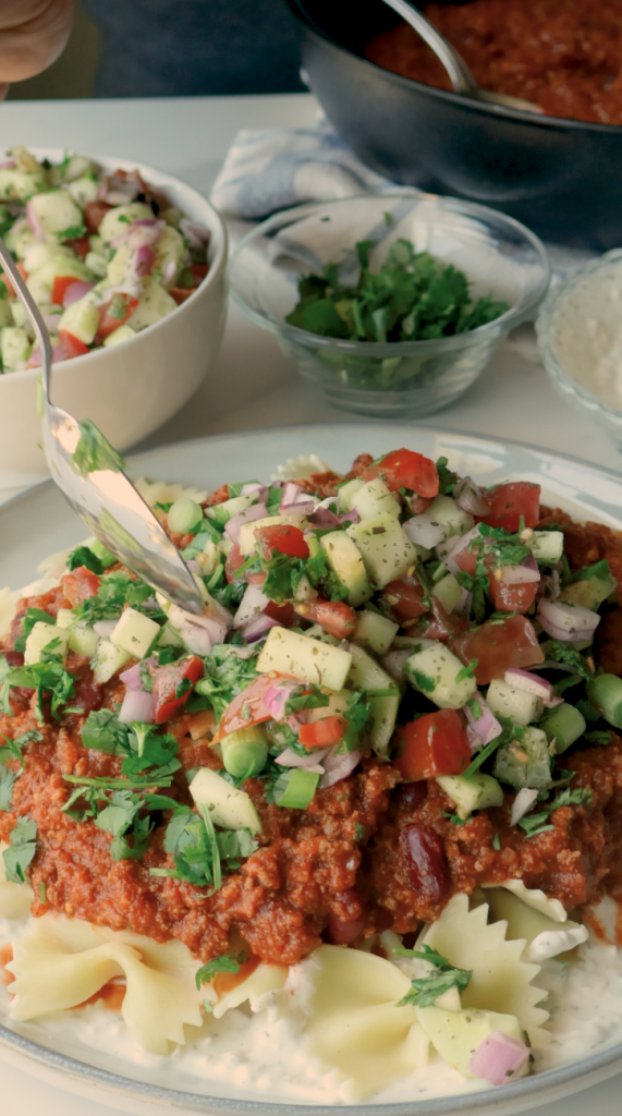 To serve, add a layer of the yogurt mix on the bottom of your plate, followed by your noodles, more yogurt and your hearty meat sauce. 
 Garnish with fresh cilantro and green onions. 